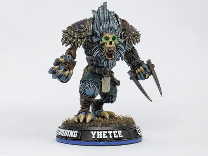 A painted Yhetee big guy on a named 40mm base